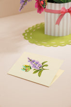 Load image into Gallery viewer, Greeting card with floral design on a table with a plant in the background
