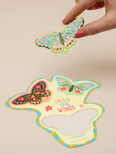 Load image into Gallery viewer, Colorful butterfly-shaped card with 'Spread Your Wings' text held by a hand on a beige background