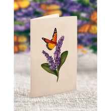 Load image into Gallery viewer, Card with a butterfly and lavender design on a textured surface with a blurred floral background.