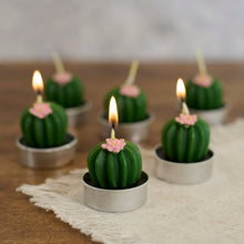 Load image into Gallery viewer, Cactus-shaped candles with pink flowers on top, arranged on a wooden surface.
