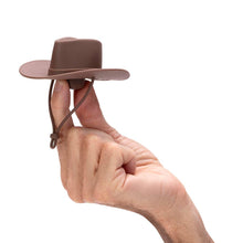 Load image into Gallery viewer, Hand holding a small brown cowboy hat against a white background

