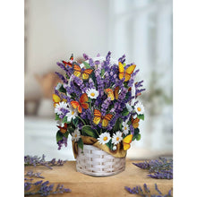 Load image into Gallery viewer, Bouquet of flowers with butterflies in a white basket on a wooden surface.
